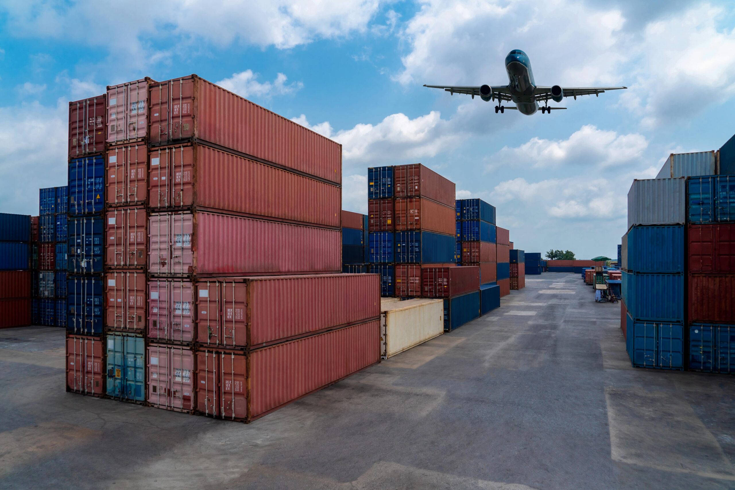 cargo-container-overseas-shipping-shipyard-with-airplane-sky